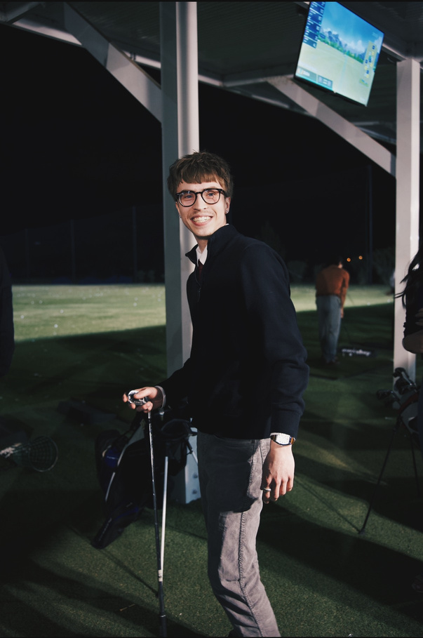 Golfer at a driving range under the lights