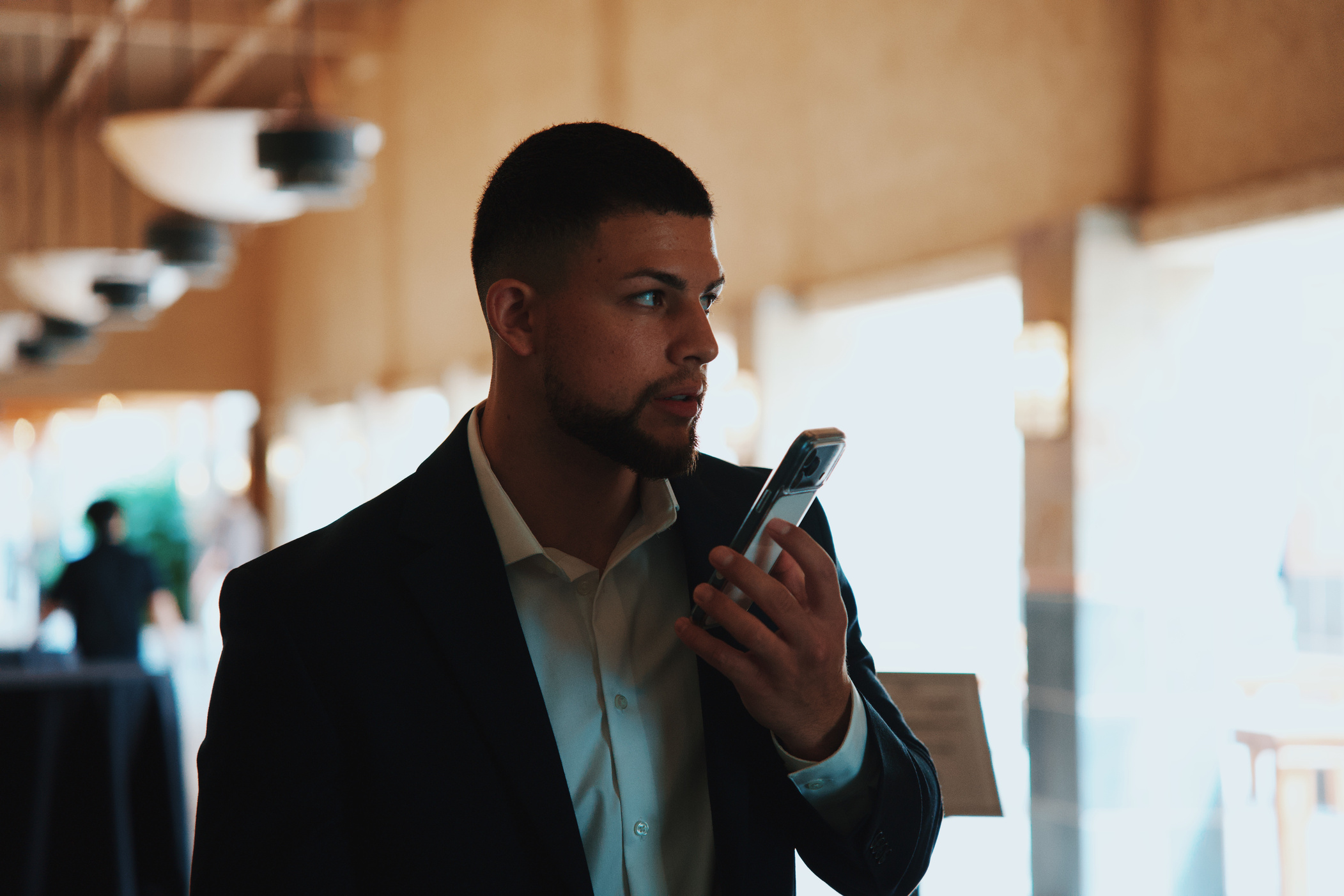 Attendee on his phone during a networking event