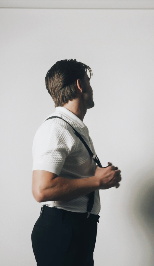 Profile studio portrait in suspenders