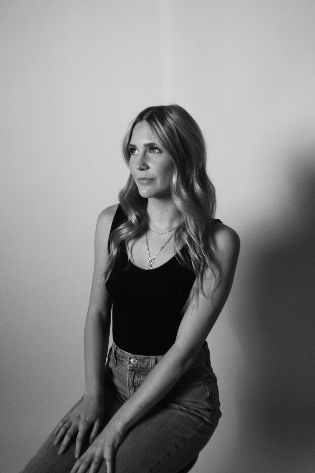 Black and white headshot against a studio backdrop
