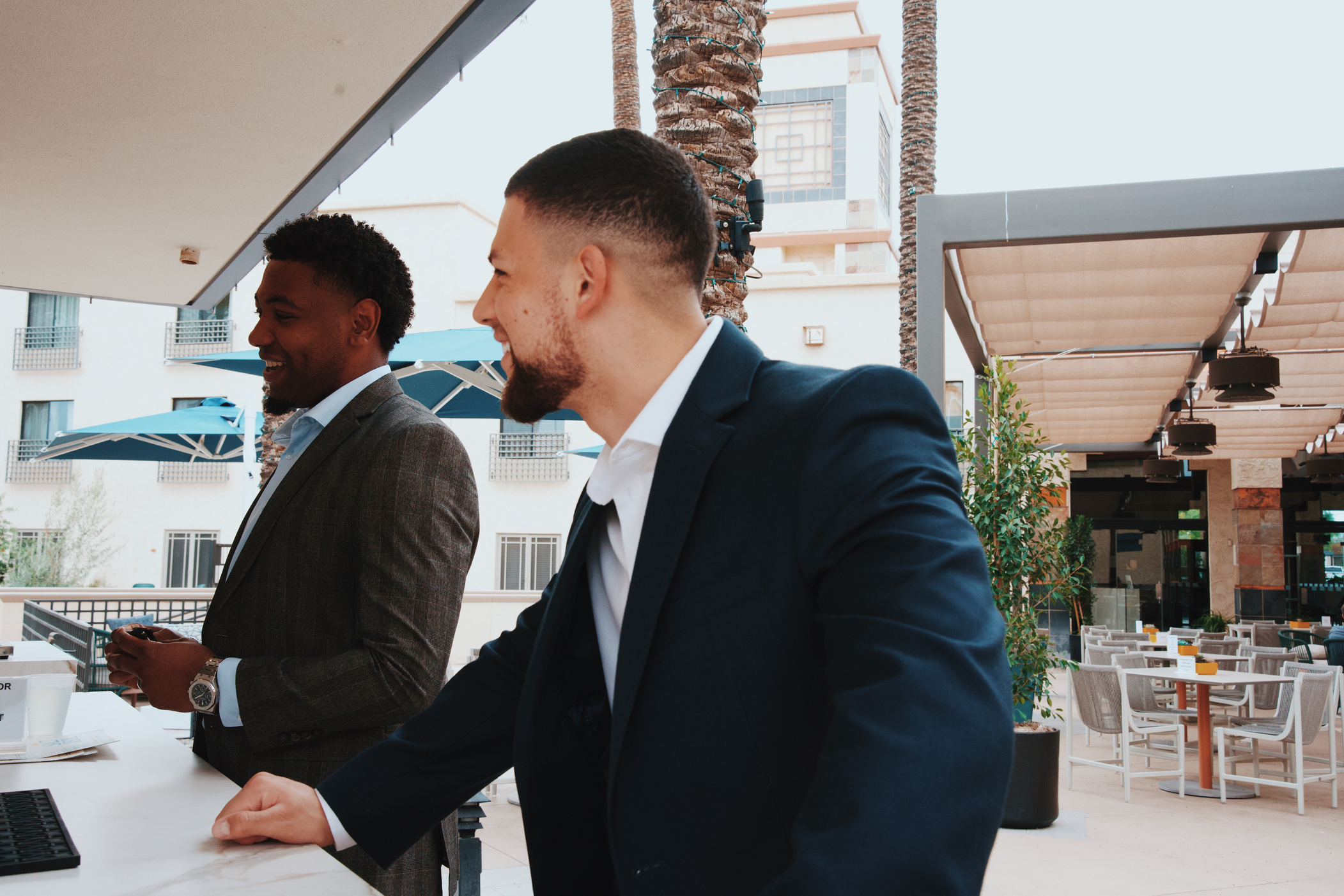 Two guests shaking hands on a rooftop patio