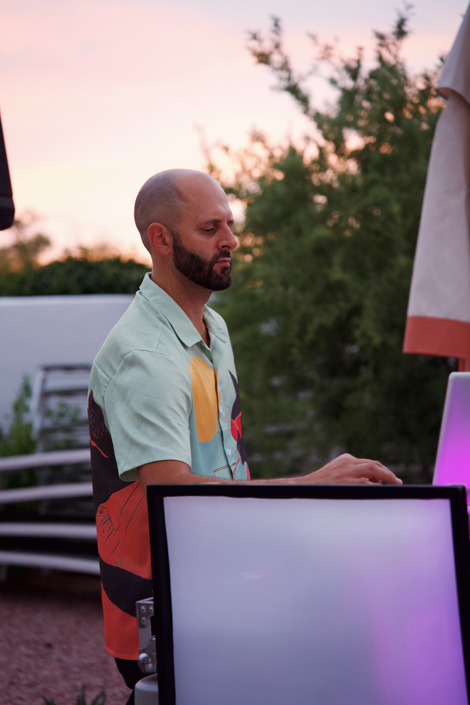 DJ performing at a poolside social hub
