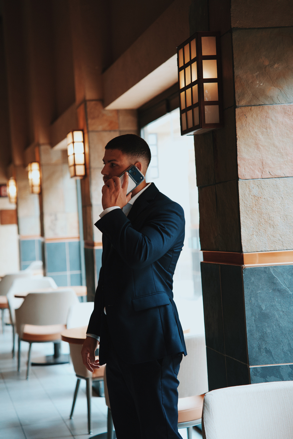 Guest taking a call in a hotel lobby
